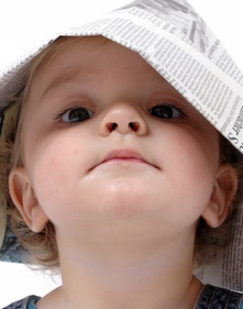 Baby Wearing Newspaper as a Hat